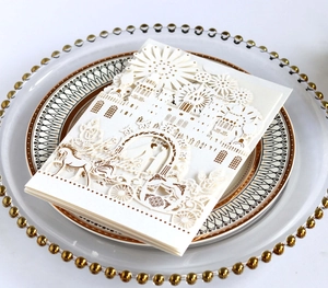 Exquisite laser cut white wedding invitation featuring a castle and horse carriage design