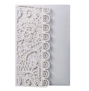Detailed laser-cut lace pattern on an elegant cream wedding invitation cover