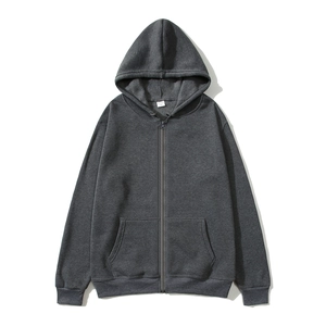 Detail of grey hooded zip-up sweatshirt showing neckline tag and fleece fabric texture