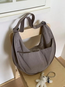 Large crescent nylon shoulder bag in taupe with adjustable strap and front pockets