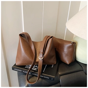 Close-up of brown lychee grain leather tote bag set with matching small zipper pouch