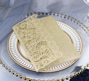 Detailed laser-cut floral pattern on shimmering champagne gold wedding invitation card