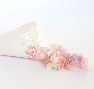 Detailed close-up of white laser-cut hollow heart cone for wedding dried flowers