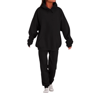 Men's solid black tracksuit featuring an oversized drawstring hoodie and joggers