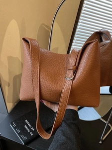 Large dark brown pebble leather tote bag with adjustable silver buckle shoulder strap