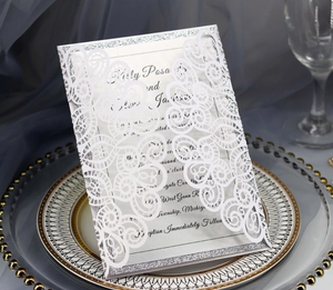 Laser cut white wedding invitation with floral hollow pattern and silver glitter border