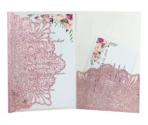 Detail of pink glitter laser-cut wedding invitation with elegant floral card insert