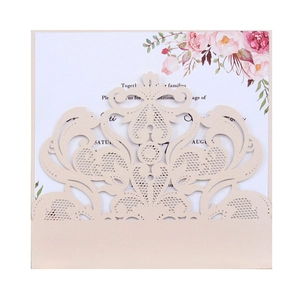 Detailed view of cream laser-cut lace wedding invitation with floral insert and pearl finish