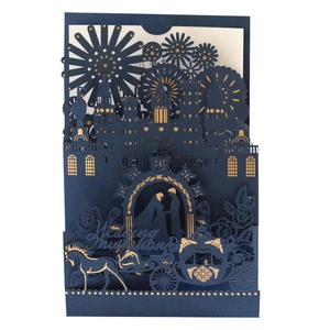 Navy blue laser-cut wedding invitation with gold foil castle and horse carriage design
