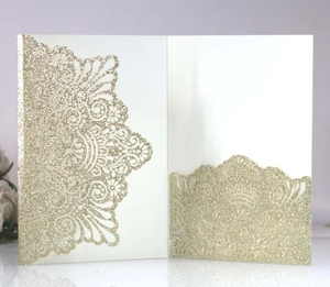 Detailed laser-cut floral pattern with gold glitter on ivory wedding invitation card