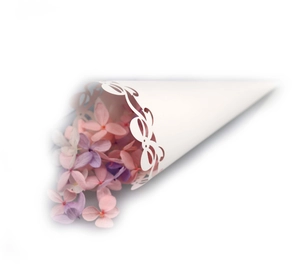 Close-up of white laser-cut lace wedding petal cones with elegant hollow patterns