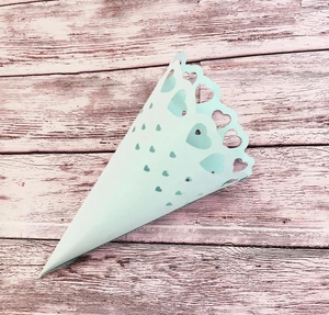 Detail of light blue wedding confetti cone with laser-cut heart hollow pattern