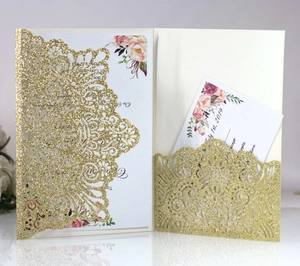 Detailed laser-cut gold glitter wedding invitation with elegant floral inner card