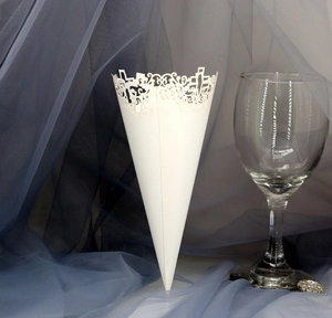 Detailed laser-cut hollow lace patterns on a white paper wedding confetti cone