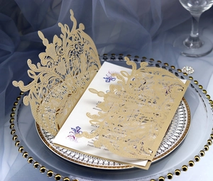 Elegant laser cut pink wedding invitation set with floral inner card on glass plate