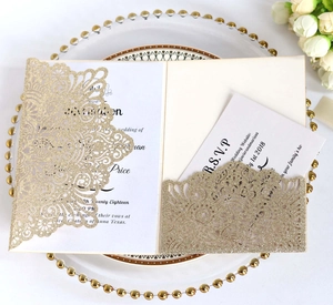 Detail of champagne gold glitter laser-cut wedding invitation with RSVP card and floral pattern