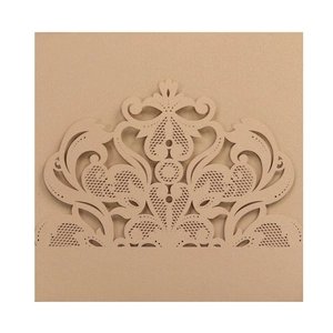 Detailed laser-cut lace pattern on champagne gold pearlized paper wedding invitation