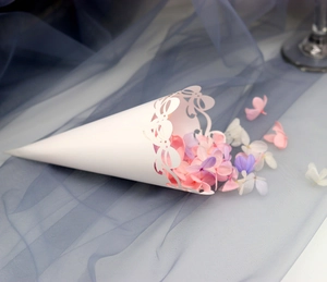 Close-up of white laser-cut lace cone filled with pink and purple flower petals