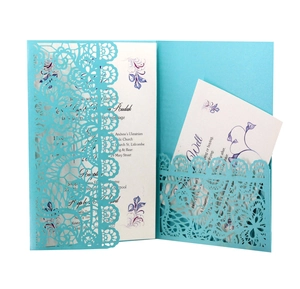 Detailed view of sky blue laser-cut lace wedding invitation with insert card