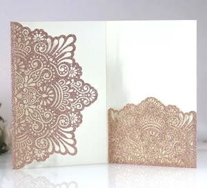 Macro view of rose gold laser-cut invitation with glitter finish and lace pattern