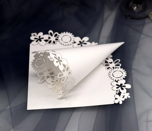 Detailed laser-cut white wedding confetti cone with elegant sunflower lace pattern