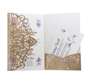 Detail of laser-cut gold glitter wedding invitation with elegant floral inner page cards