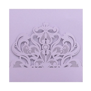 Macro detail of laser-cut lavender invitation cover with elegant floral lace pattern