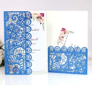 Detailed laser cut floral lace pattern on royal blue glitter wedding invitation cover