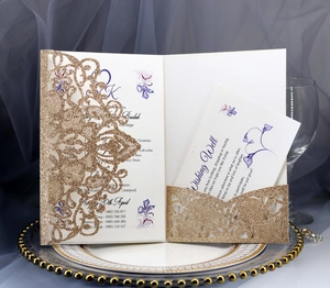 Detail of laser-cut gold glitter wedding invitation with elegant hollow lace pattern