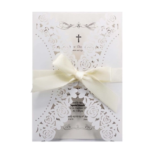 Laser cut white rose wedding invitation set with cream ribbon and religious cross detail