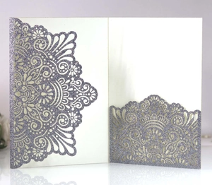 Macro view of purple laser cut mandala pattern with glitter finish on wedding invitation