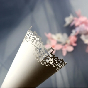 White laser cut confetti cones with cross patterns for wedding and religious ceremonies
