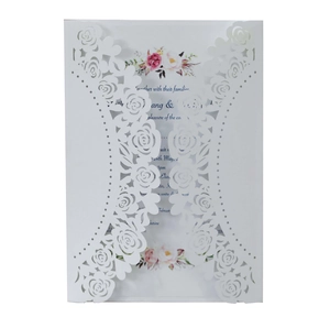 Close-up of laser-cut rose hollow wedding invitation with elegant floral inner card