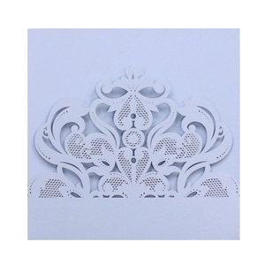 Detail of laser cut lace wedding invitation with intricate floral patterns in pearl blue