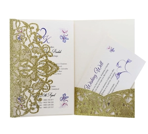 Macro detail of laser-cut gold glitter wedding invitation with floral printed insert card