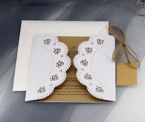 Laser cut wedding invitation set with white rose patterns and kraft paper card