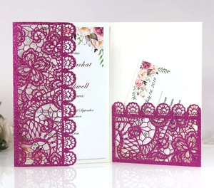 Detail of laser-cut floral invitation pocket with glitter texture and printed inserts
