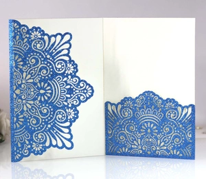 Detail of laser-cut navy blue glitter invitation with intricate mandala lace hollow design