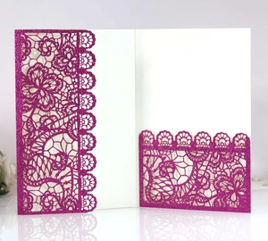 Detailed laser cut floral pattern on magenta glitter wedding invitation card cover