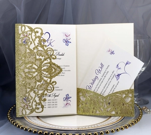 Detail of laser-cut gold glitter wedding invitation with floral inner card on porcelain