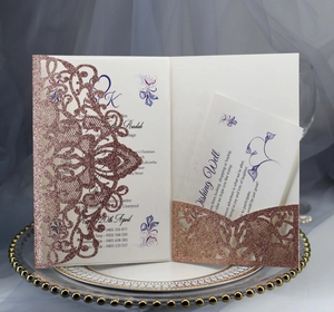 Macro shot of rose gold glitter laser-cut wedding invitation with floral insert card