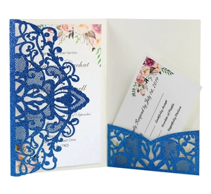 Detail of laser-cut wedding invitation with blue glitter finish and floral interior