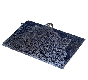 Detail showing the intricate laser-cut floral pattern on deep blue glitter cardstock