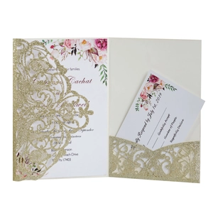Macro detail of laser cut glitter gold wedding invitation set with floral inner cards