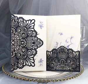 Detailed laser-cut dark blue glitter wedding invitation with floral inner card