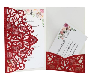 Detail of red glitter laser-cut wedding invitation with elegant hollow floral pattern