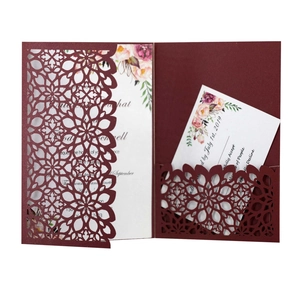 Detail of laser-cut burgundy floral invitation with printed white insert and RSVP card