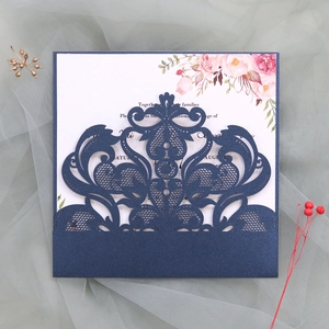 Detailed laser-cut navy blue lace wedding invitation with floral printed inner card
