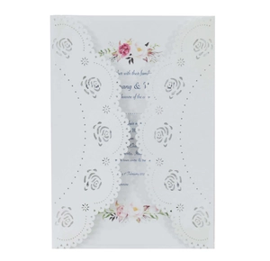 Detail of laser-cut rose hollow white card cover with elegant floral inner invitation