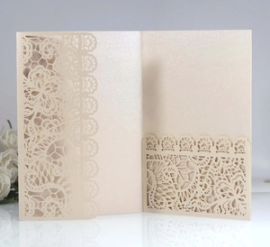 Detailed laser-cut lace wedding invitation cover in champagne pearl paper with white rose